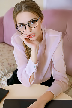 Elle Tan Puts Her Glasses Aside And Parts Her Slender Thighs So Her Short Skirt Rides Up