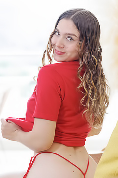 Alessia Smiles And Teases In Red On A Yellow Chair